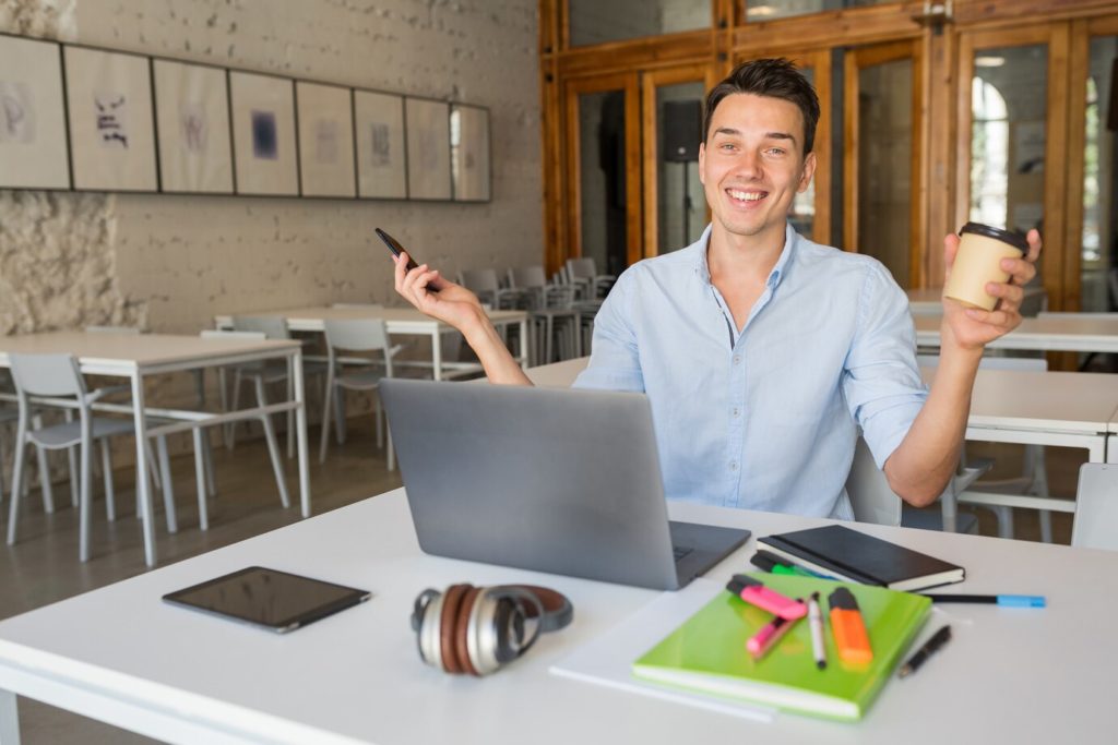 funny-smiling-happy-young-man-sitting-co-working-office-room-working-laptop_285396-1651-1024x683 Living the Contrib Experience